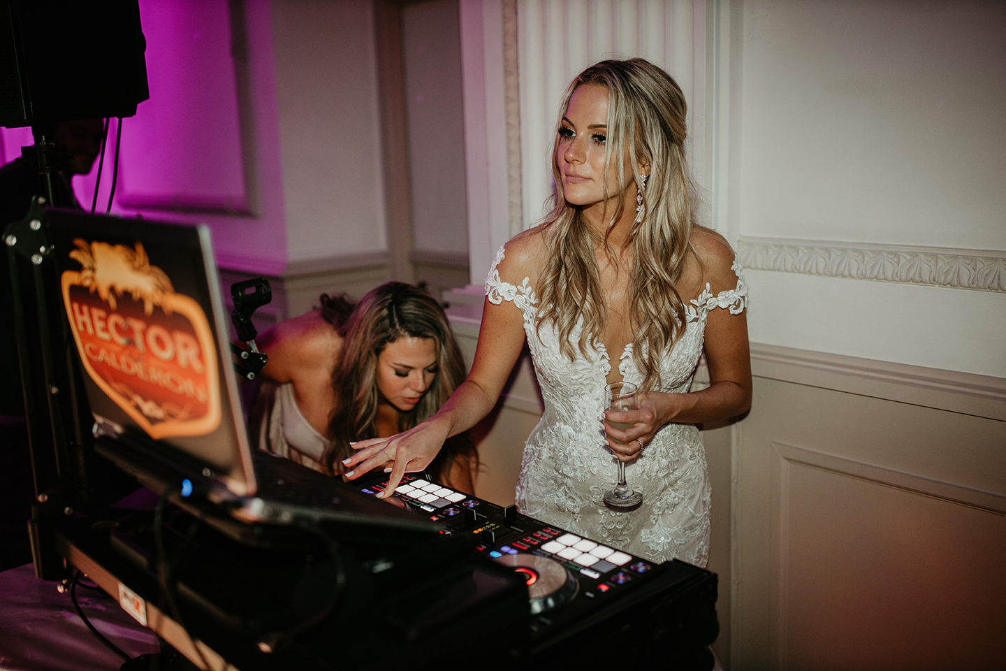 Bride at the DJ console during wedding reception