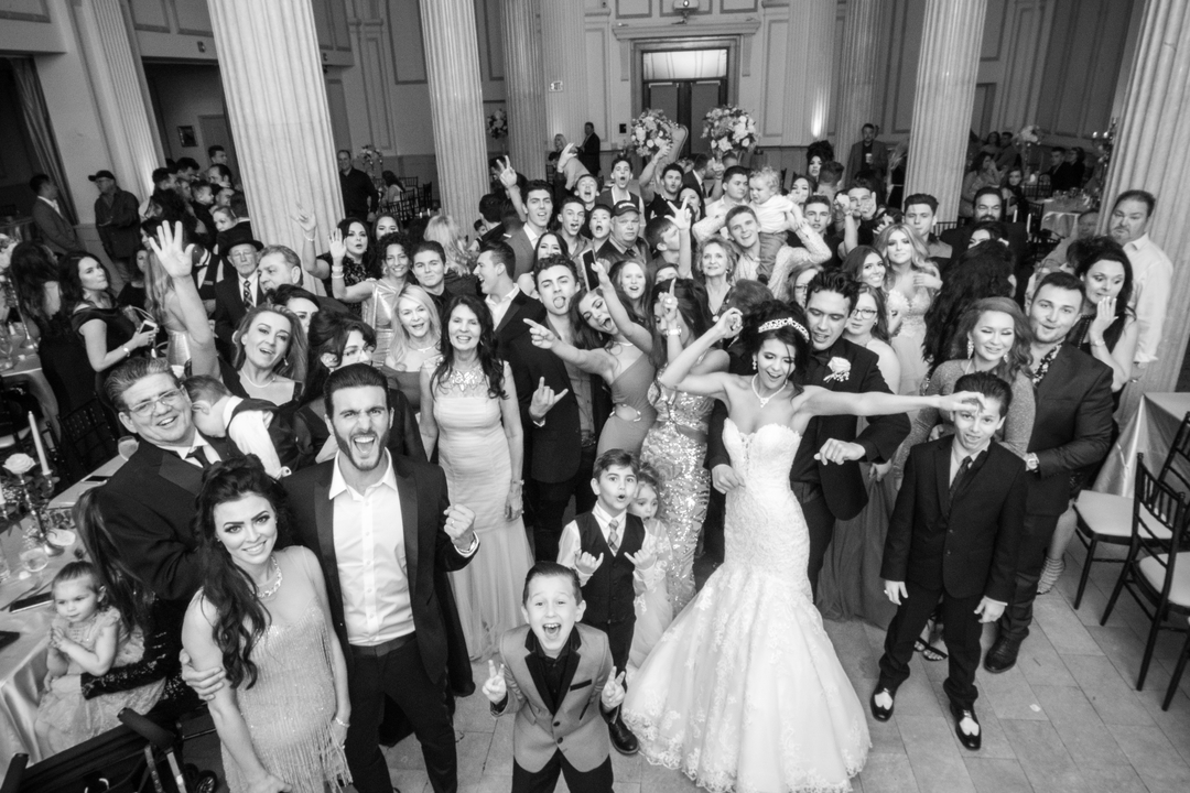 Joyful wedding crowd enjoying the DJ service